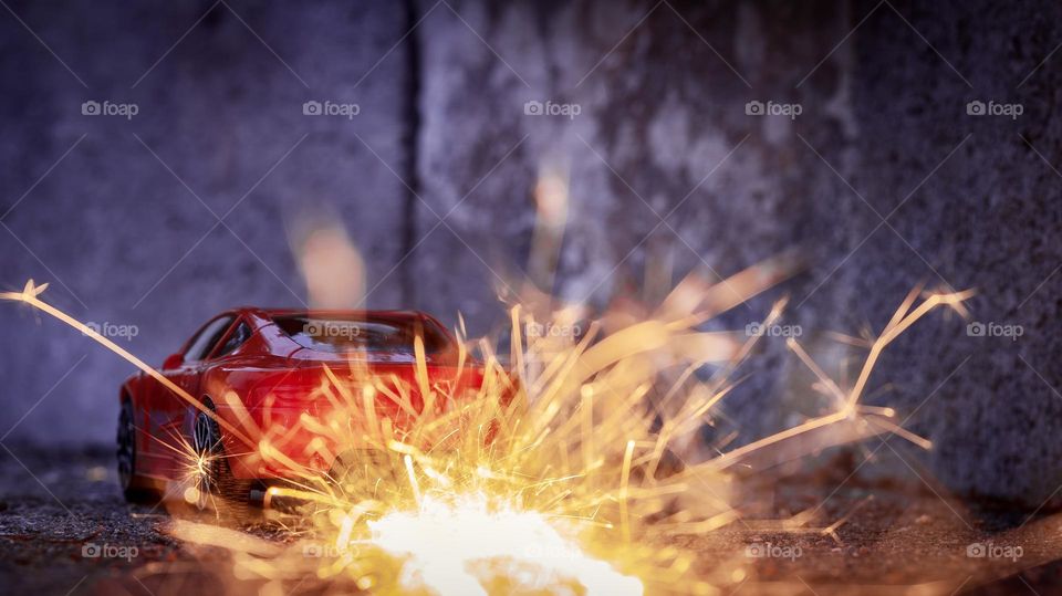 A (toy) car speeds off in a blaze of flame & sparks