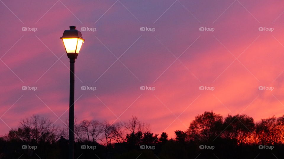 Illuminated lamp at sunset