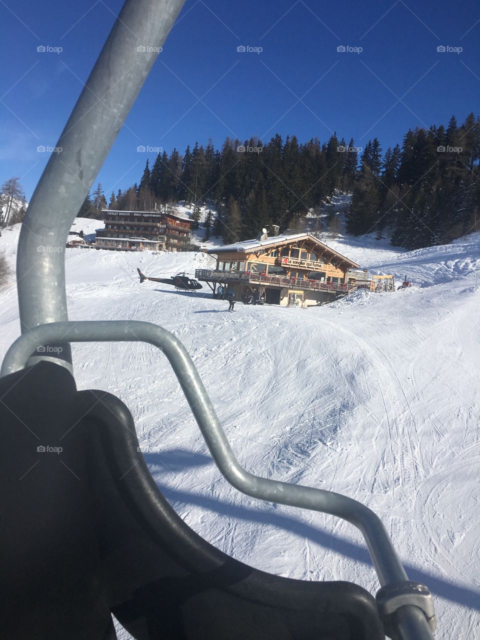 Ski restaurant on mountain with helicopter
