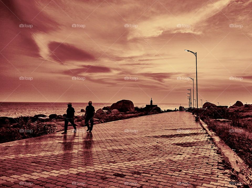 A vintage style photography of a side walk with two man having a chit chat about past times 