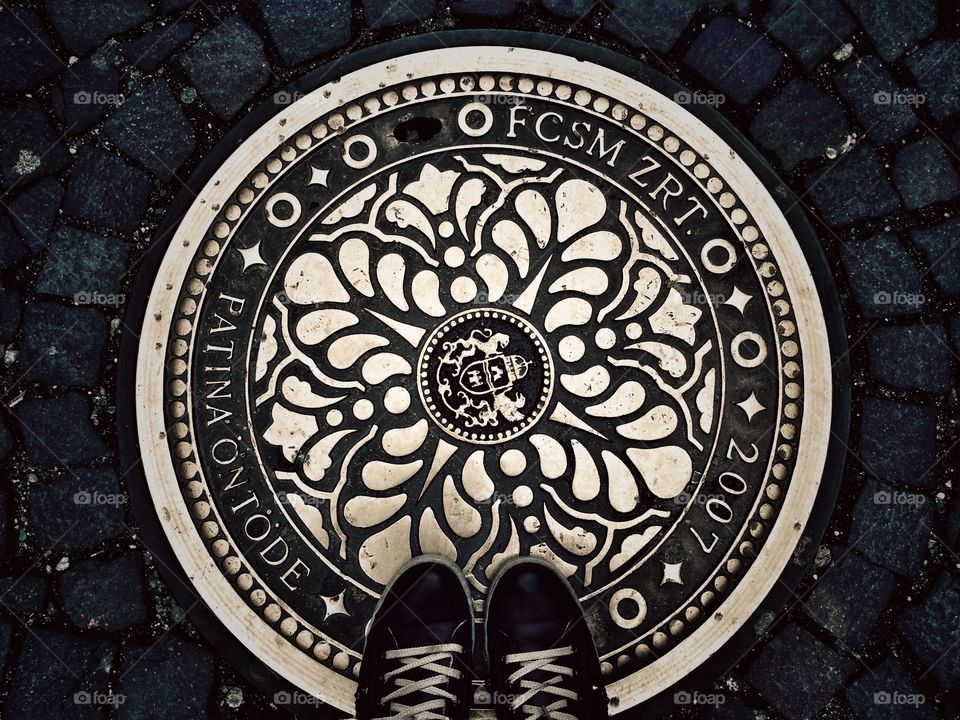 Feet and sewer on Budapest street 