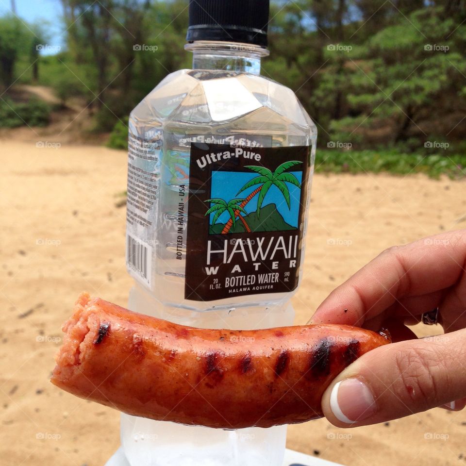 Sausage and water!. Pineapple sausage and Hawaiian water at a Maui beach 