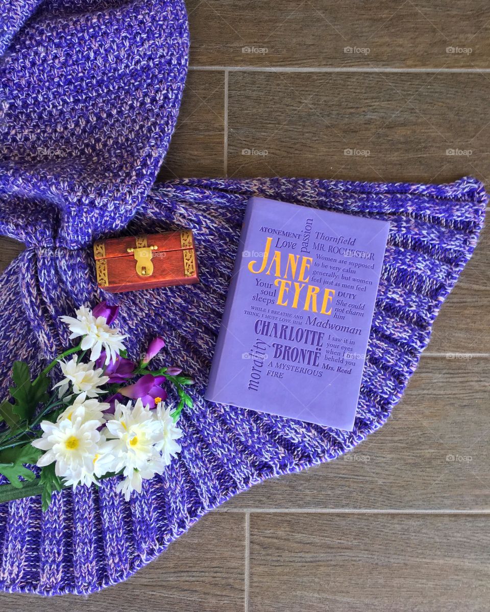Purple Jane Eyre flatlay with flowers. 