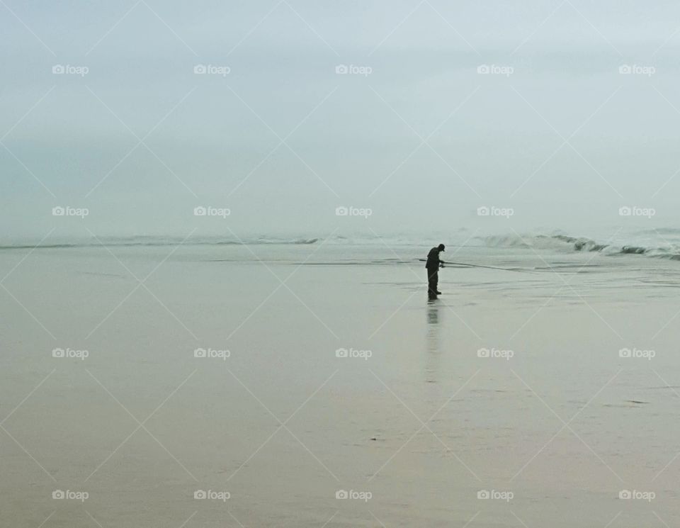 A man fishing on the Washington coast.