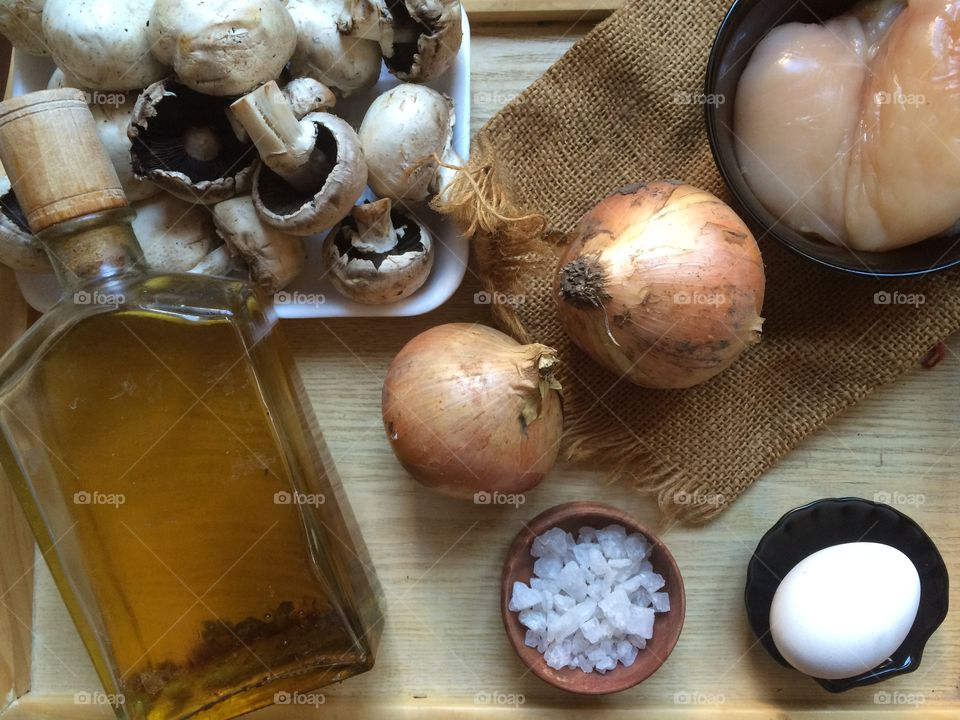food ingredients. Oil, onions, egg, mushrooms, chicken meat. 