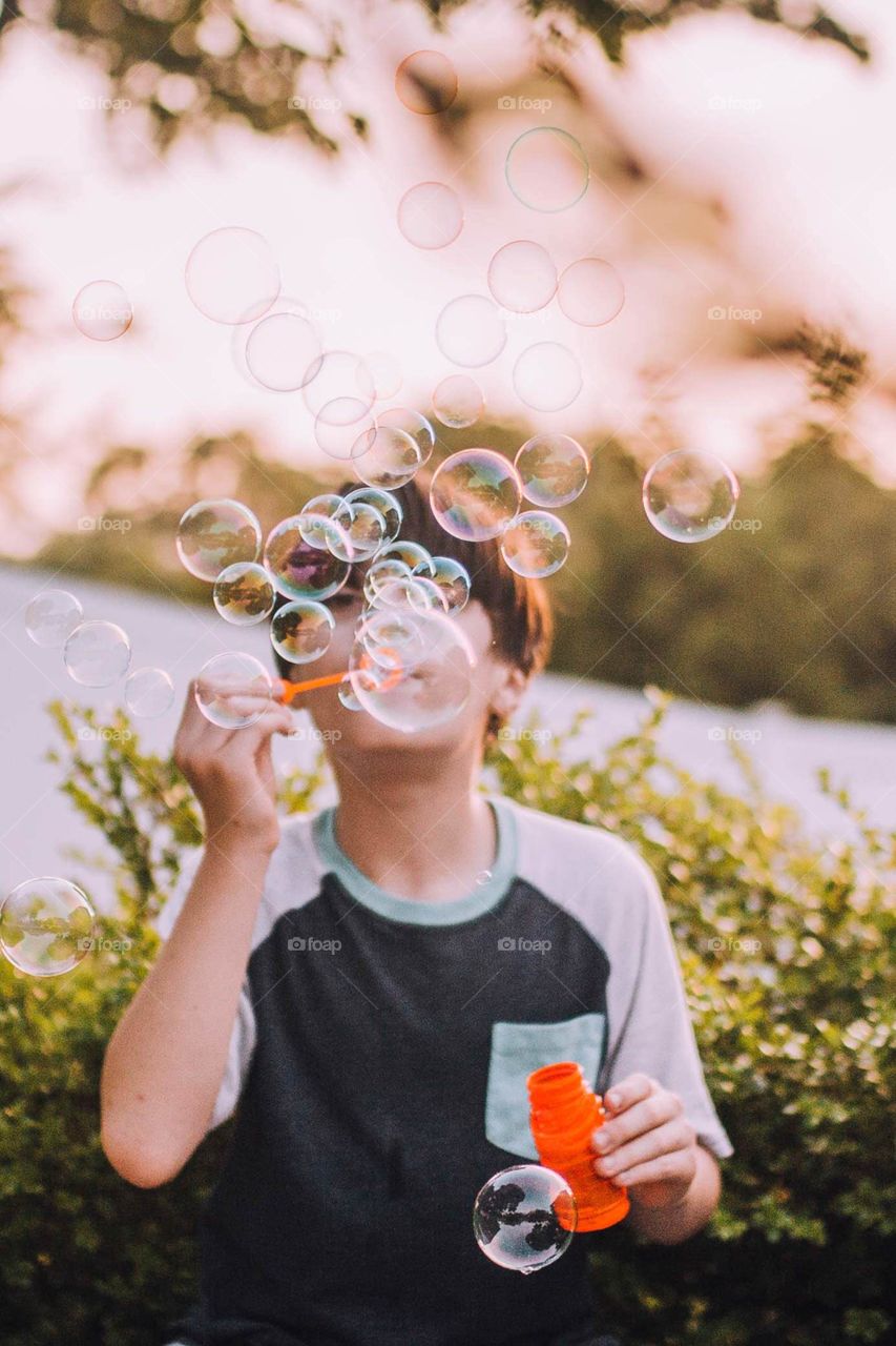 Boy blowing bubbles 