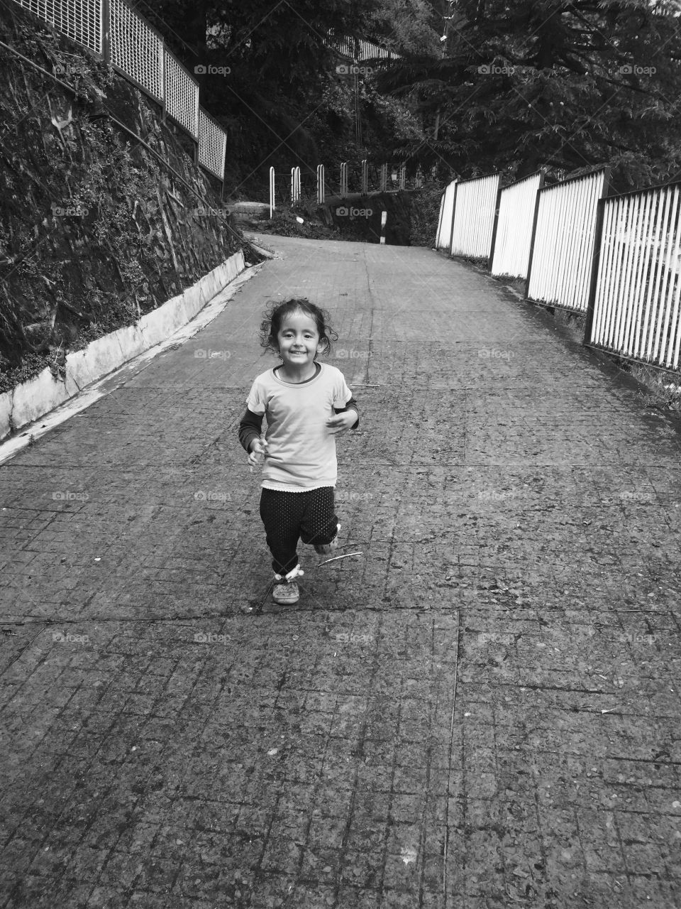 Cute little girl running on walkway