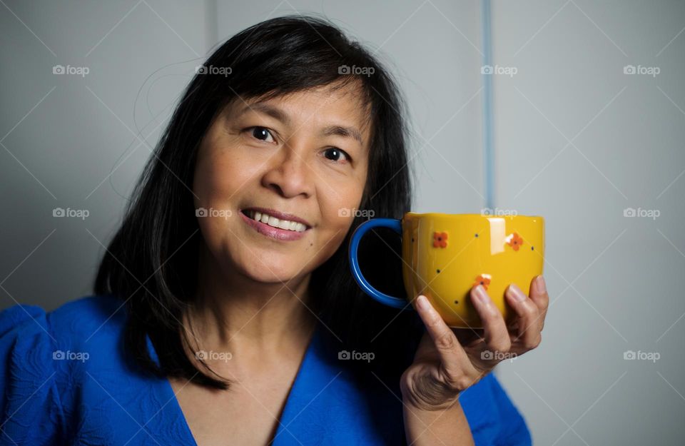 Portrait of a woman holding a cup