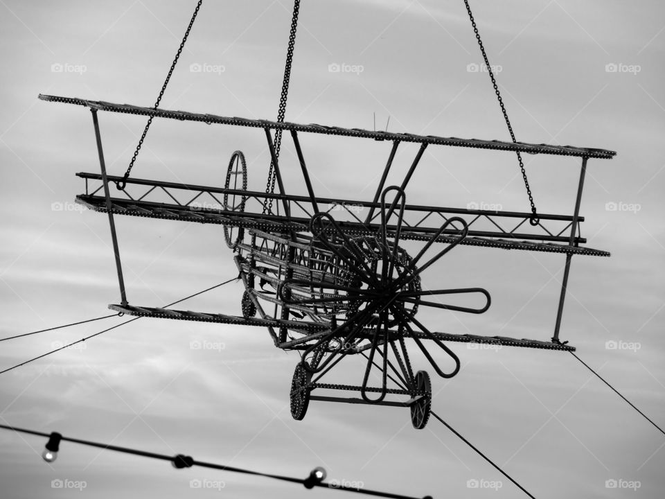 Low angle view of a light installation in the shape of a plane at an amusement park.