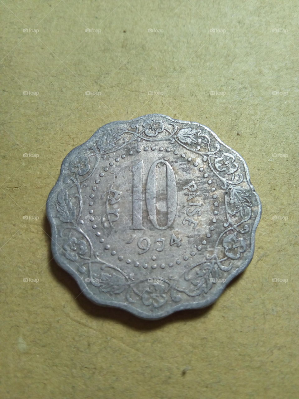 A coin of ten paise- 1/10 share of Indian Rupee issued by Government of India in 1974.
