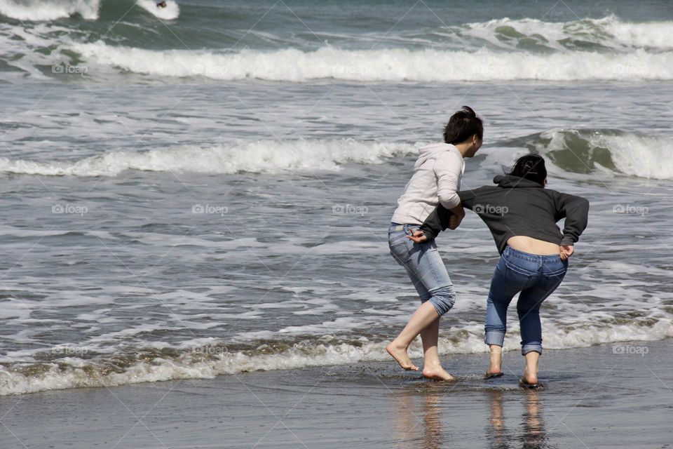 Playing girls at the beach 