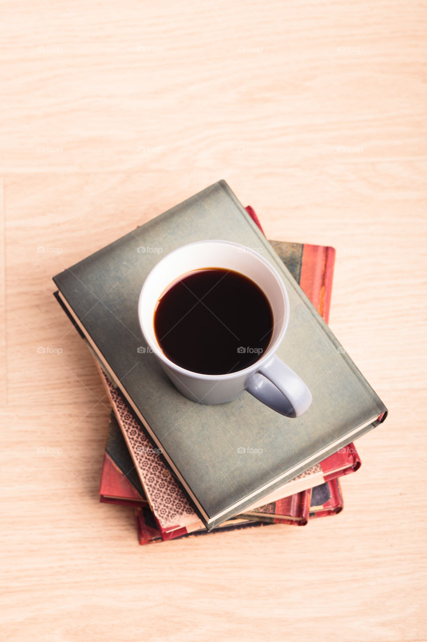 A few books with cup of coffee and cookies on wooden floor. Time for relax. Spending leisure time on reading. Cozy and comfortable. Learning from books 📖Studying for the next exam 😌