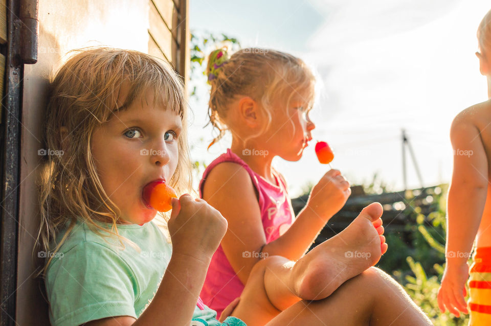 Little girls eating colorful ice-cream