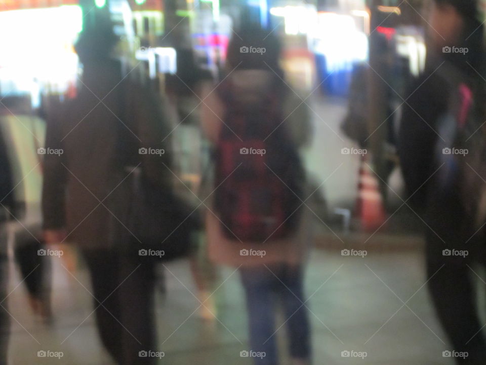 Young Japanese Couple Holding Hands, Crossing Street in Akihabara, Tokyo, Japan