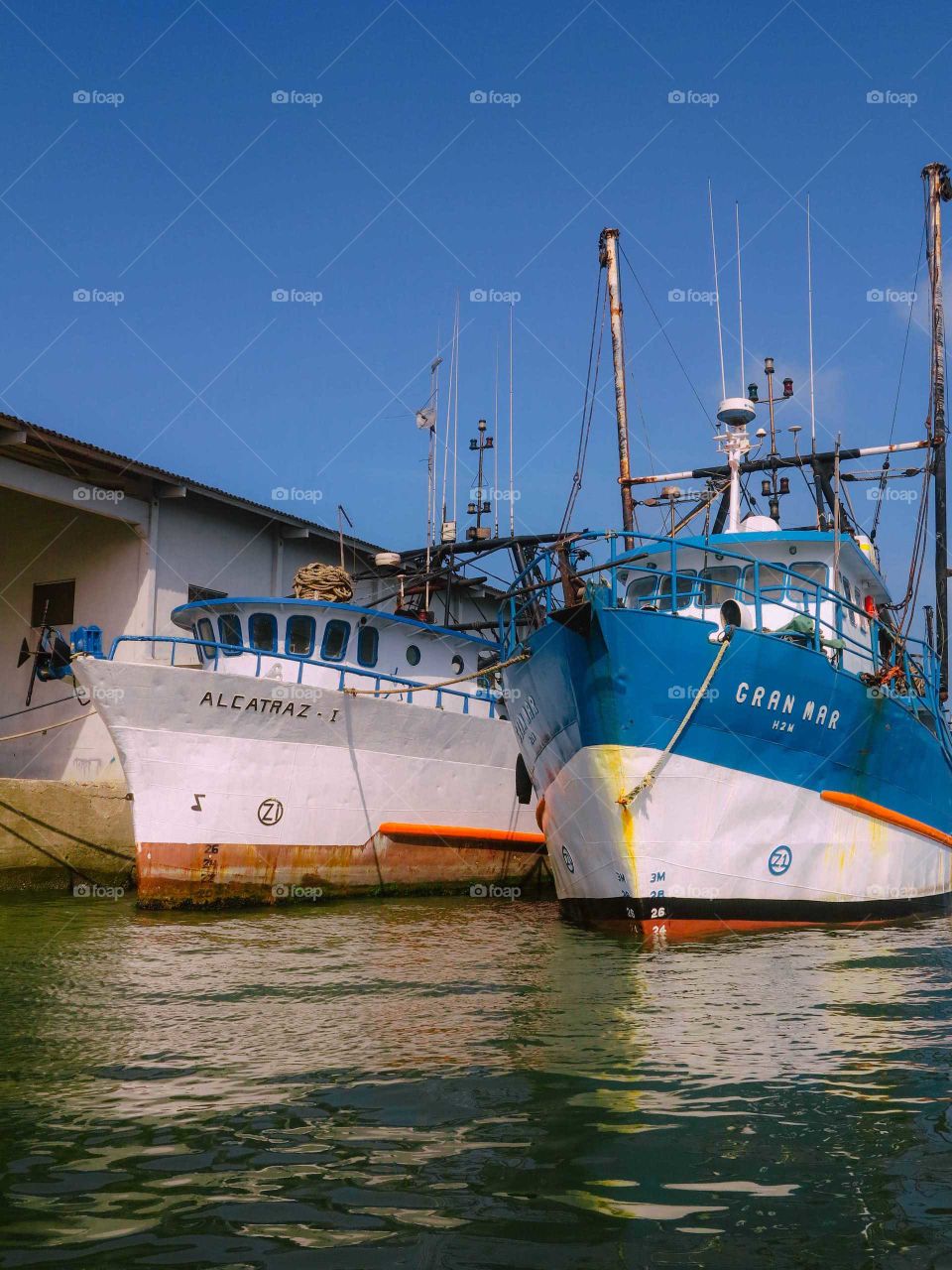 ships at Santo's port harbour, beautiful nautical scene, blue fishing boats at the docks.