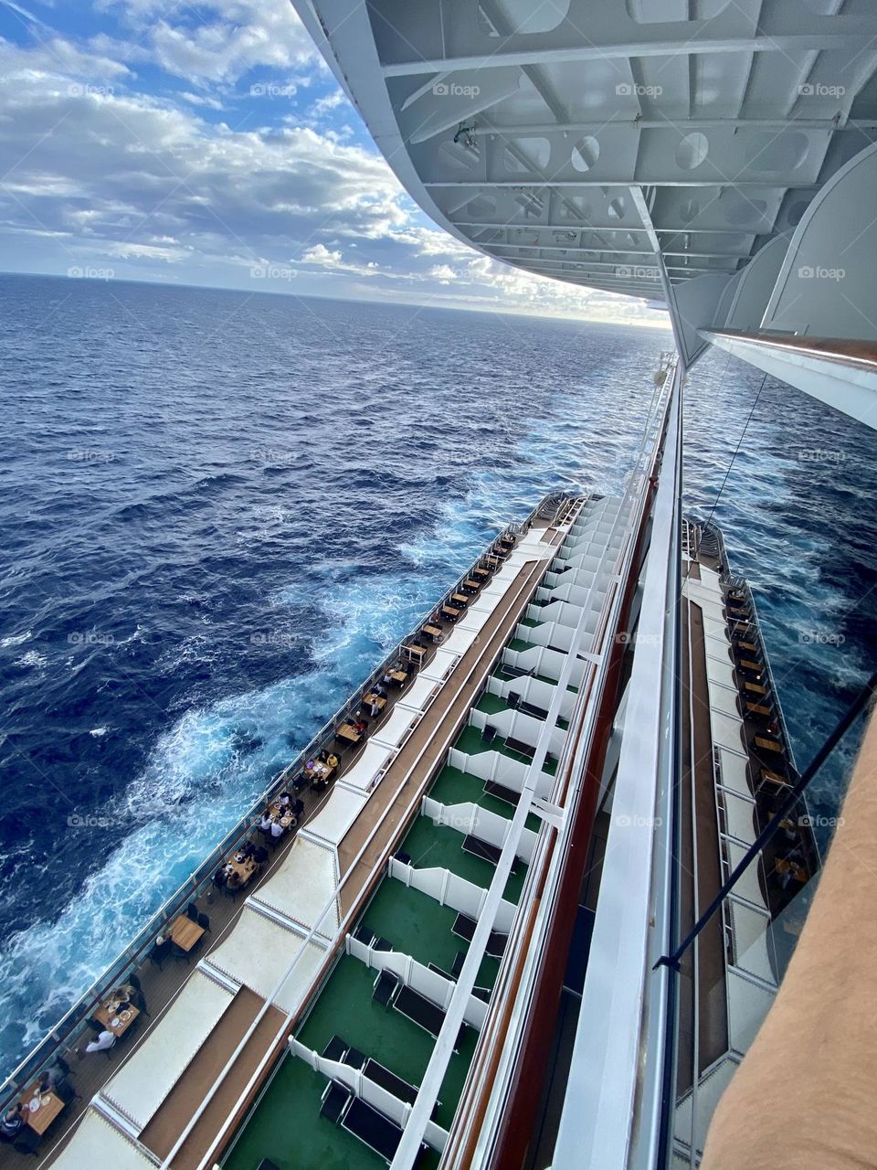 white waves in the blue sky against the backdrop of a double rainbow after the morning rain