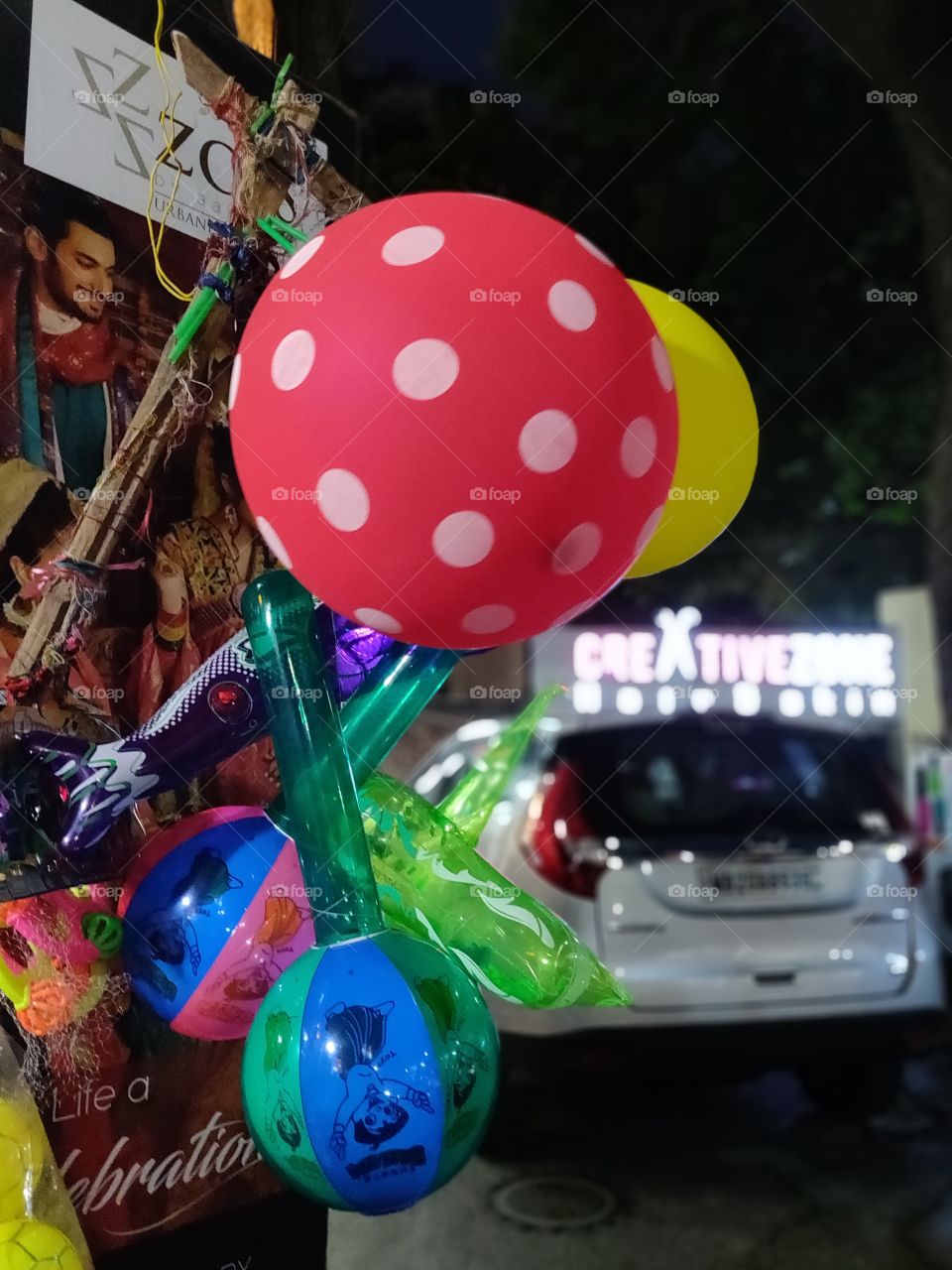 colorful display of balloon and toys on the footpath by the street vendor
