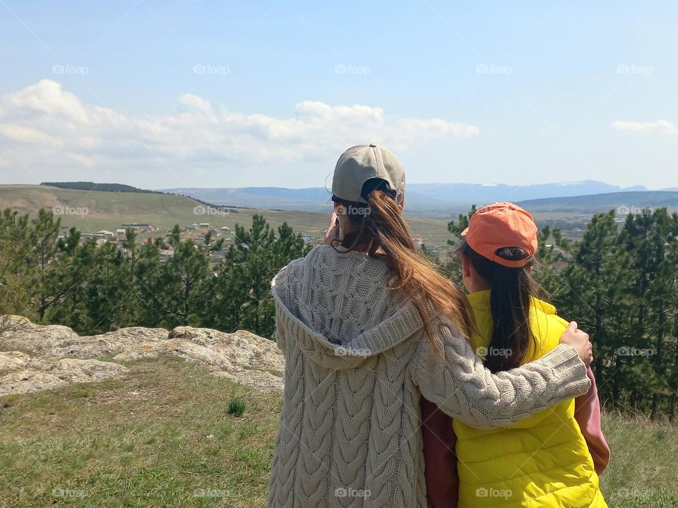 sisters looking at a beautiful view of nature.