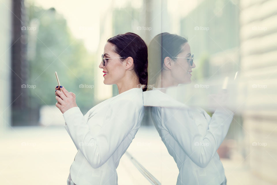 A business woman holding smartphone