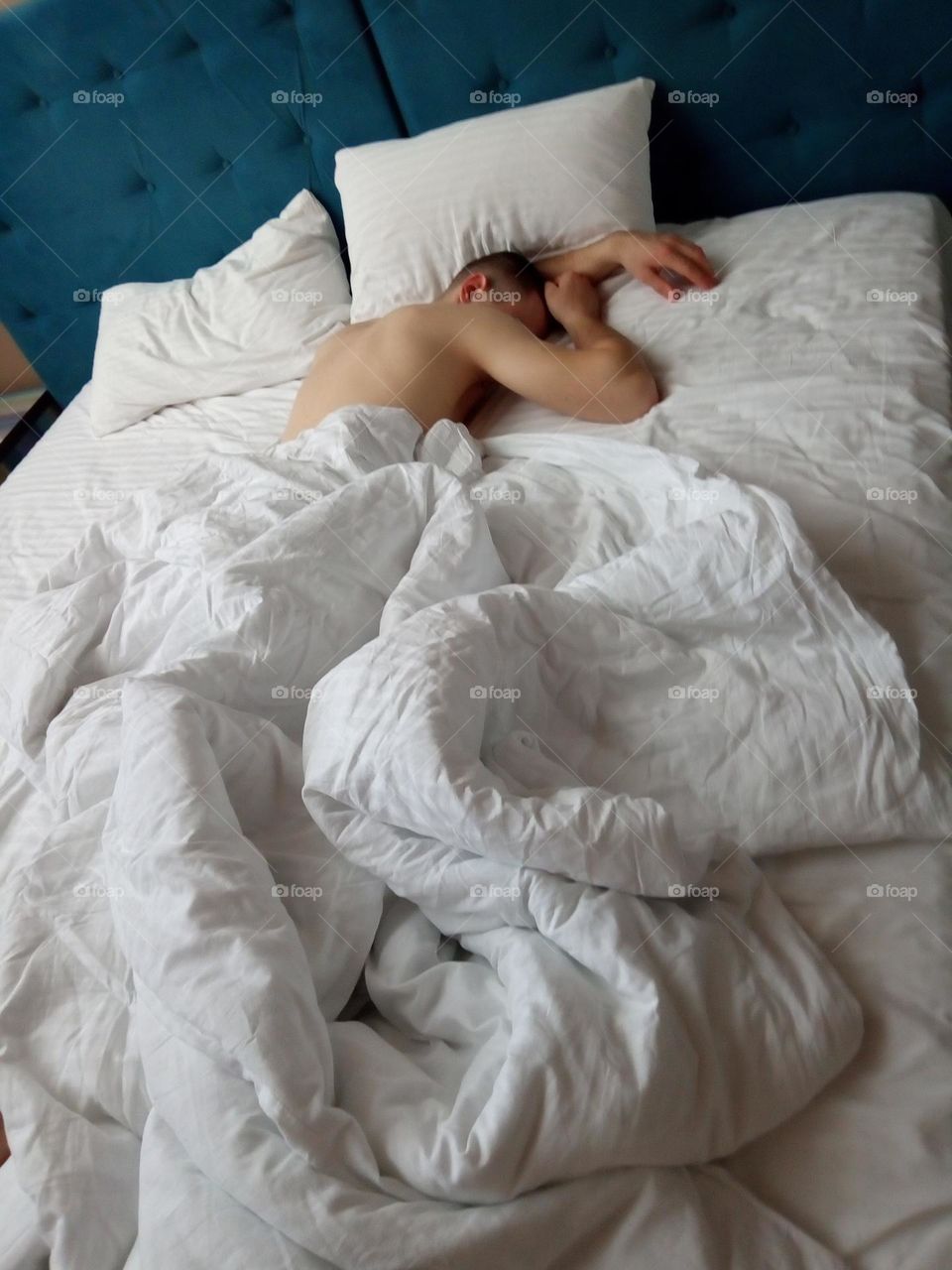 Resting in a hotel room with white sheets