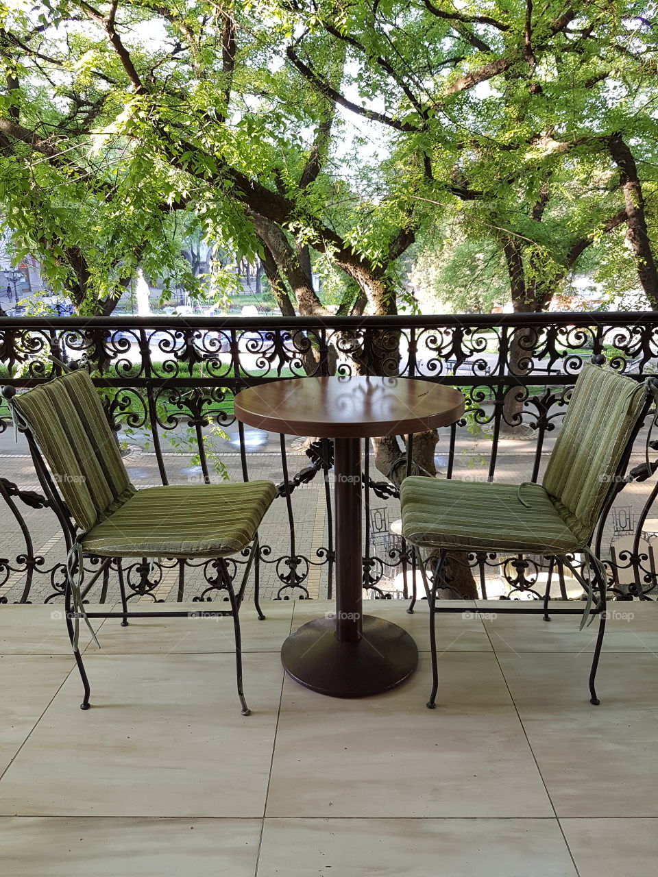 restaurant terrace with empty iron tables and chairs