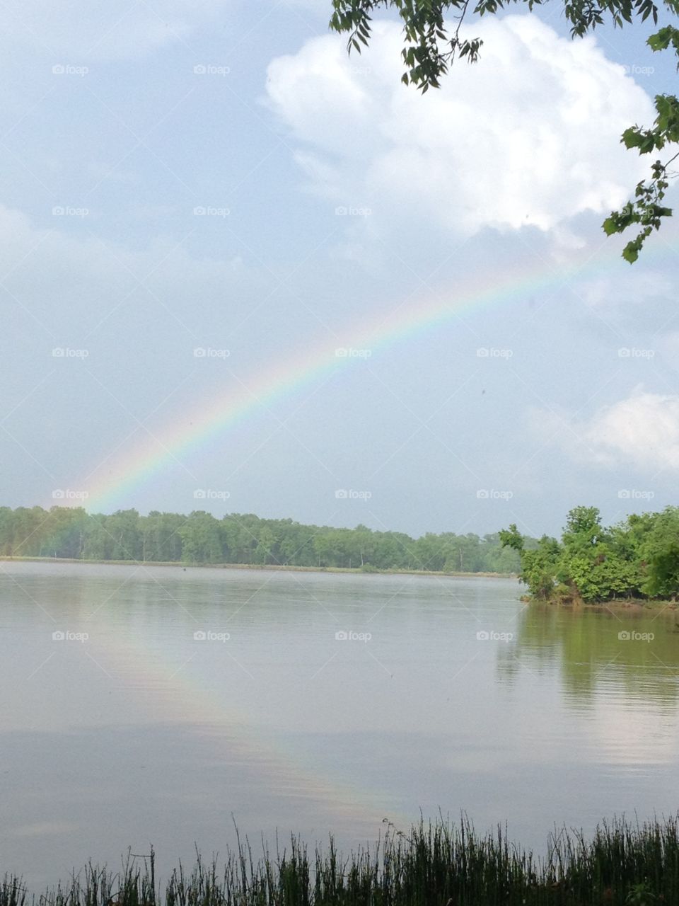River rainbow. Rainbow, river, water, sky, clouds