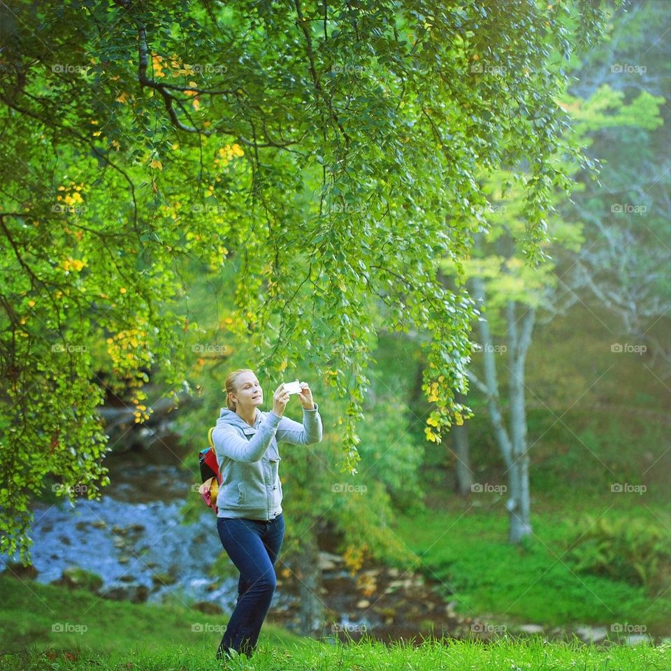 Nature. Girl photographing nature