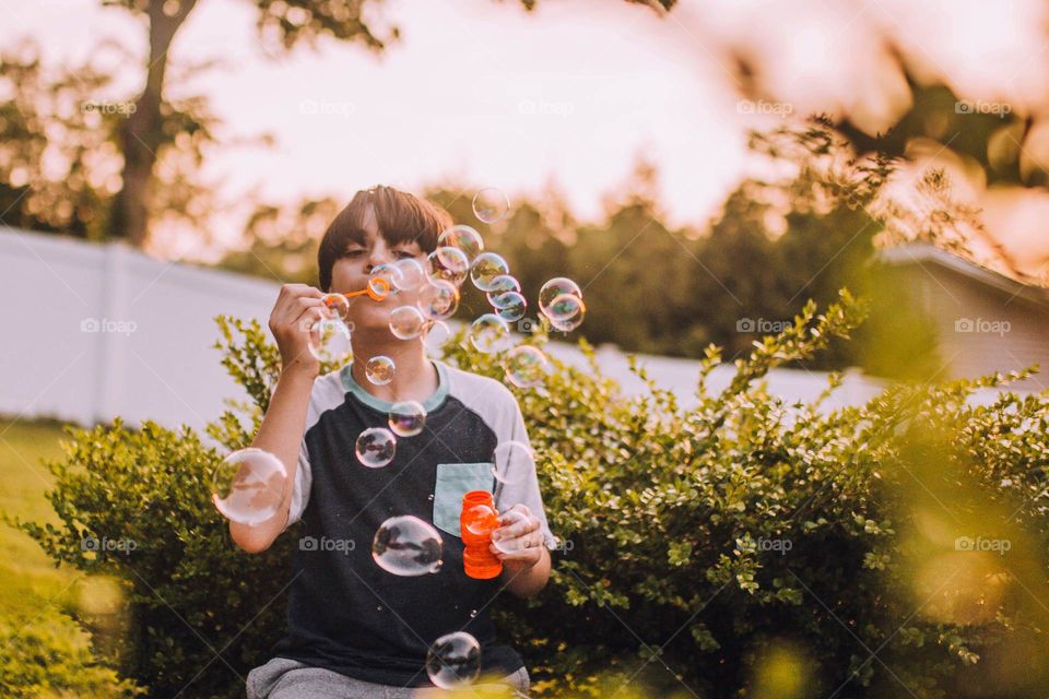 Boy blowing bubbles 