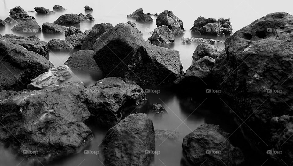 large rocks on the beach that are useful for breaking waves