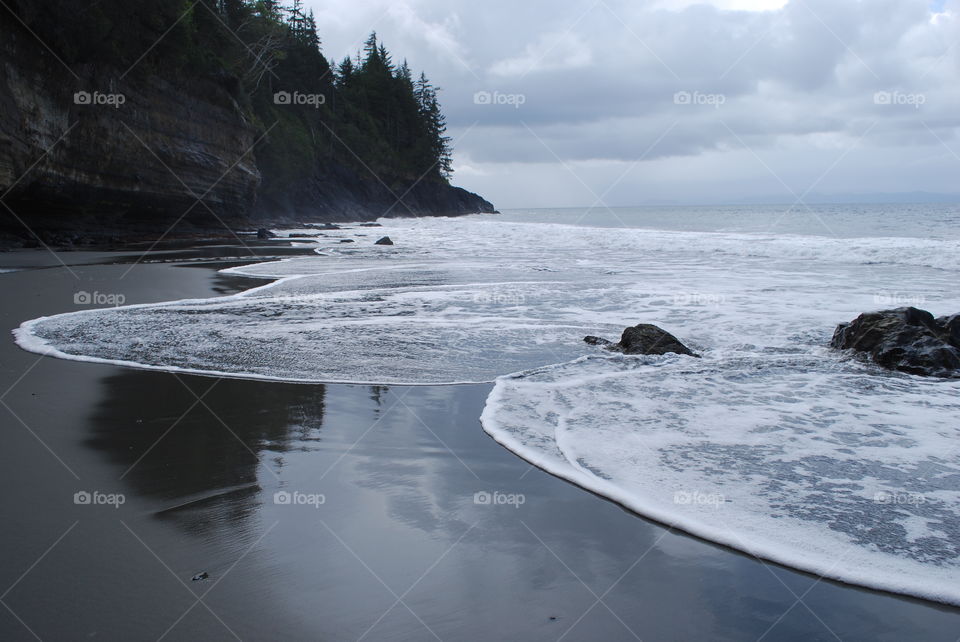 Beach against cloudy sky