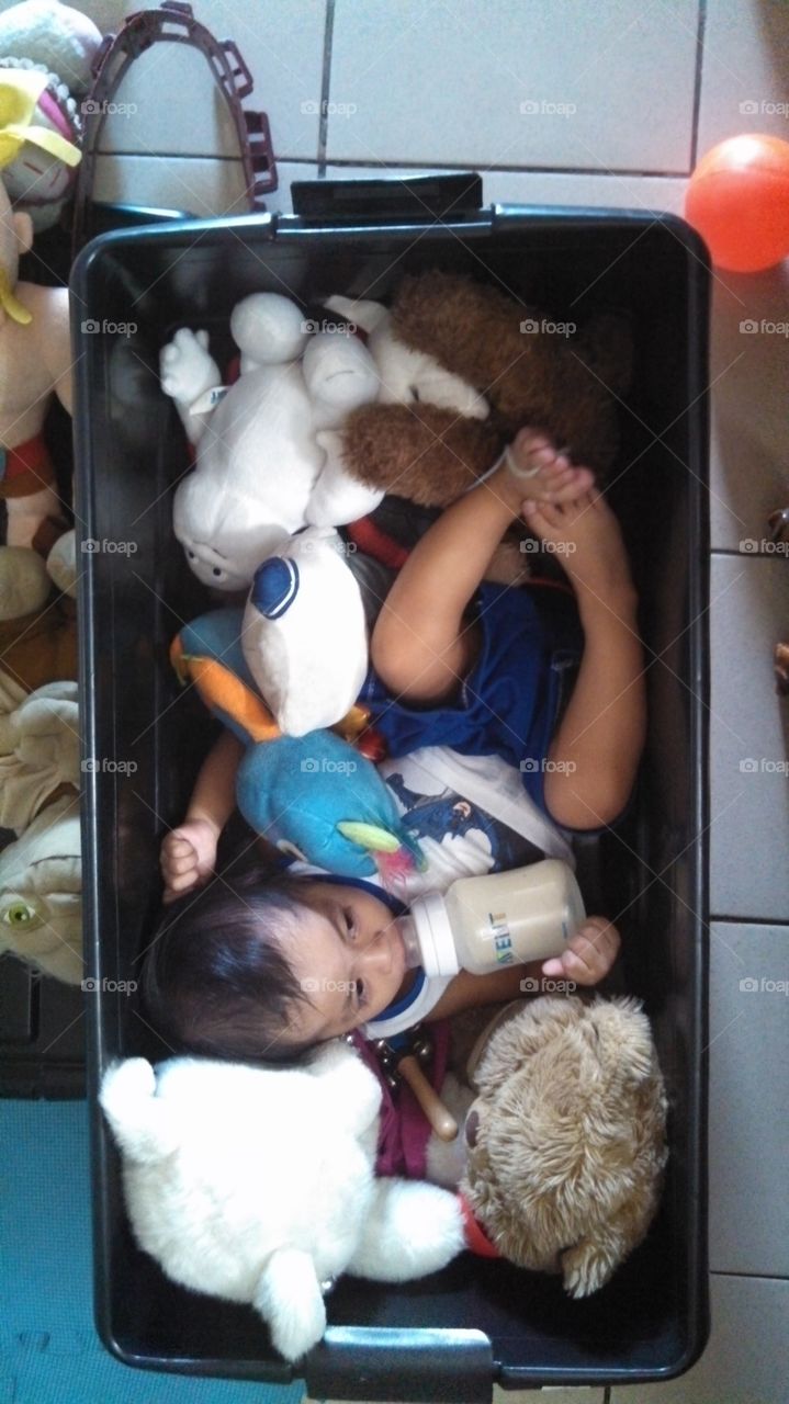 baby in a box with toys