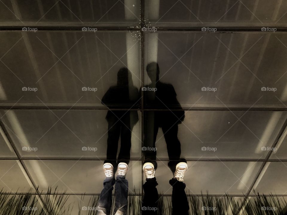 Upside down at rooftop glass floor above mall