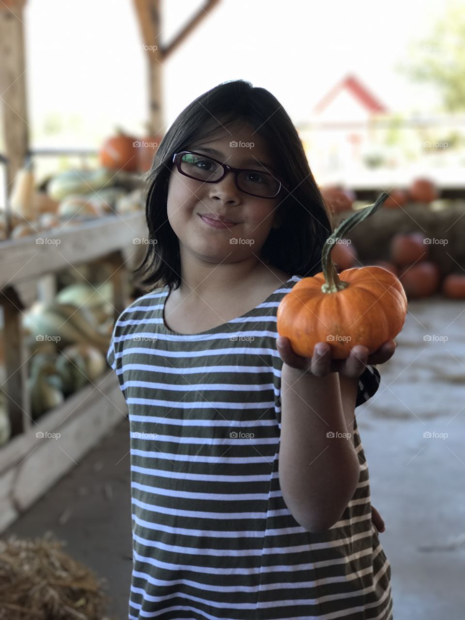 Girl's hand holding pumpkin