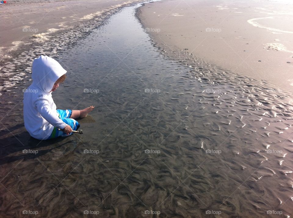 Child on the Beach. A toddler boy playing in the sand on the beach. Photo taken in Folly Beach, SC.