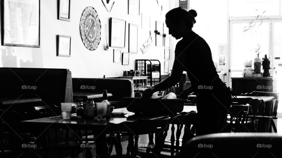 Restaraunt Work. Woman working in a restaraunt in vivid black and white. 