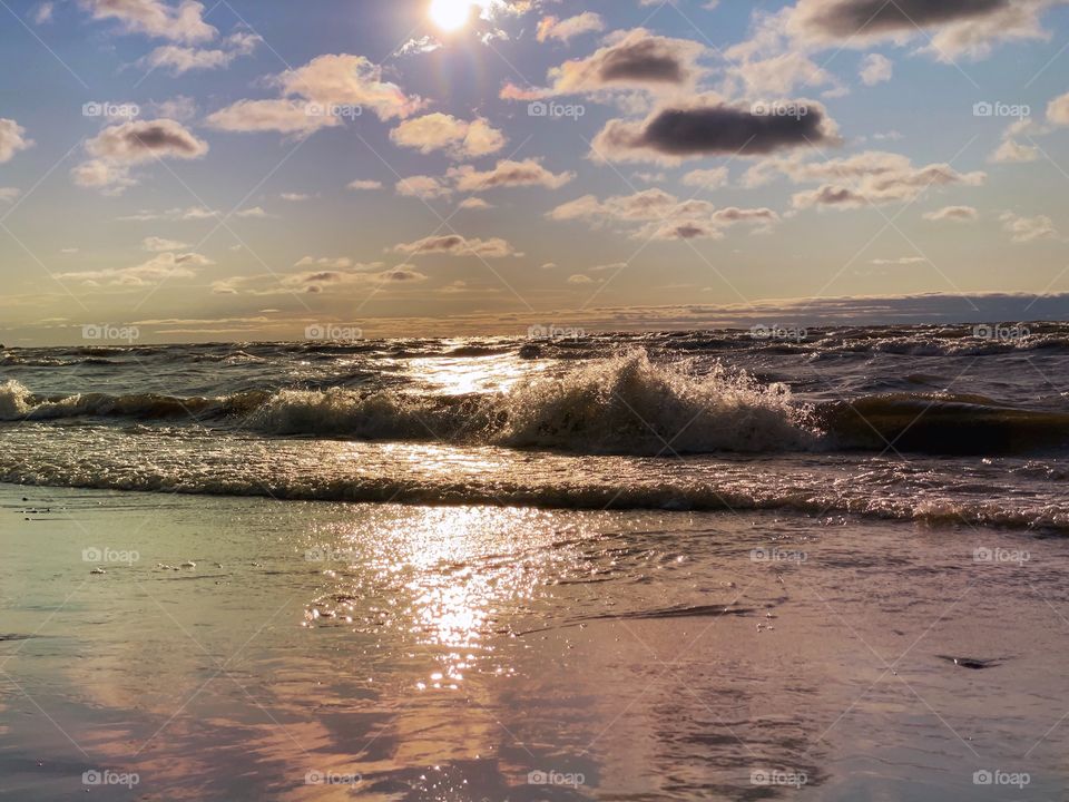 Waves crashing at sunset