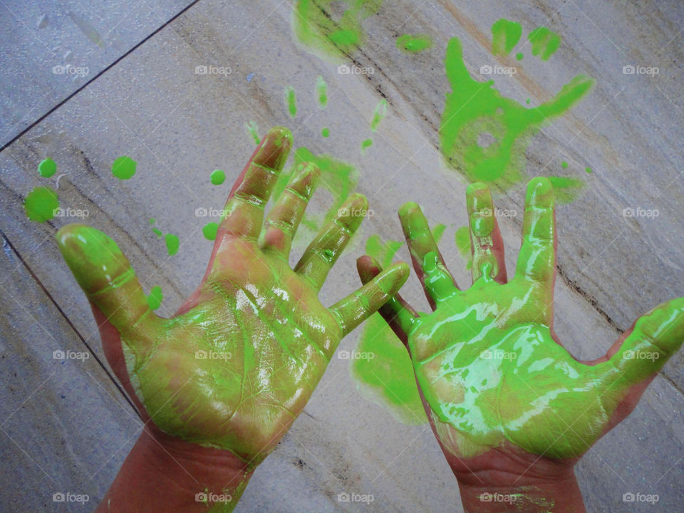 Close-up of green paint hand