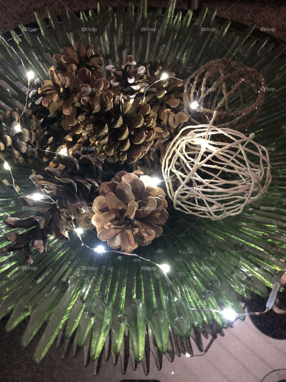 Peaceful evening at home with twinkle lights, pine cones, and diy yarn balls. 