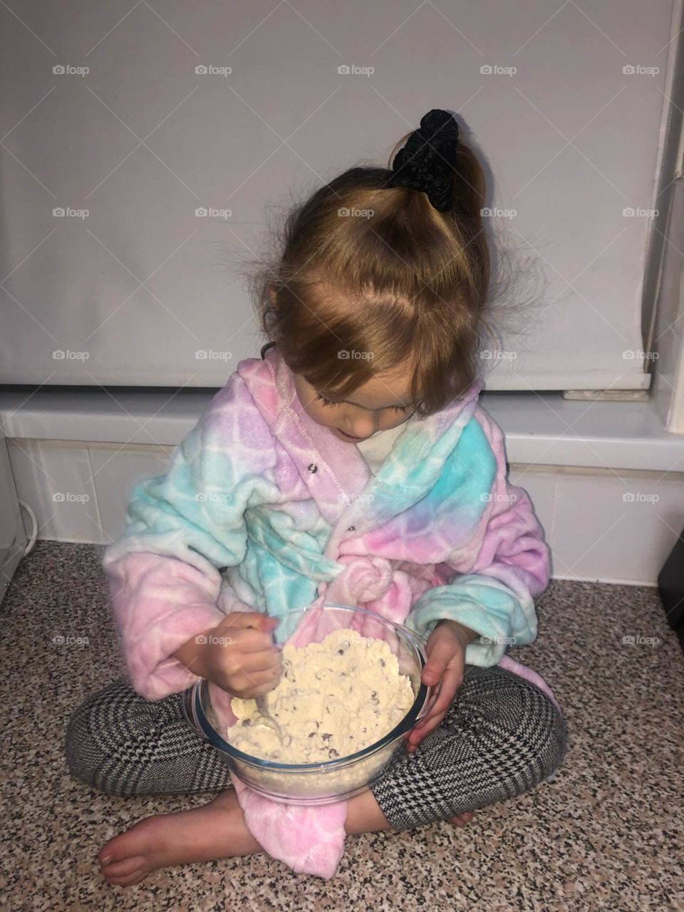 Little girl mixing her Christmas cookies ready to be baked 
