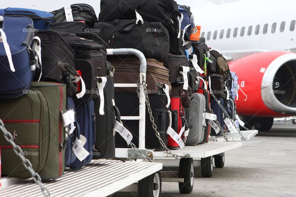 Luggage bags being transported to cargo compartment for a departure