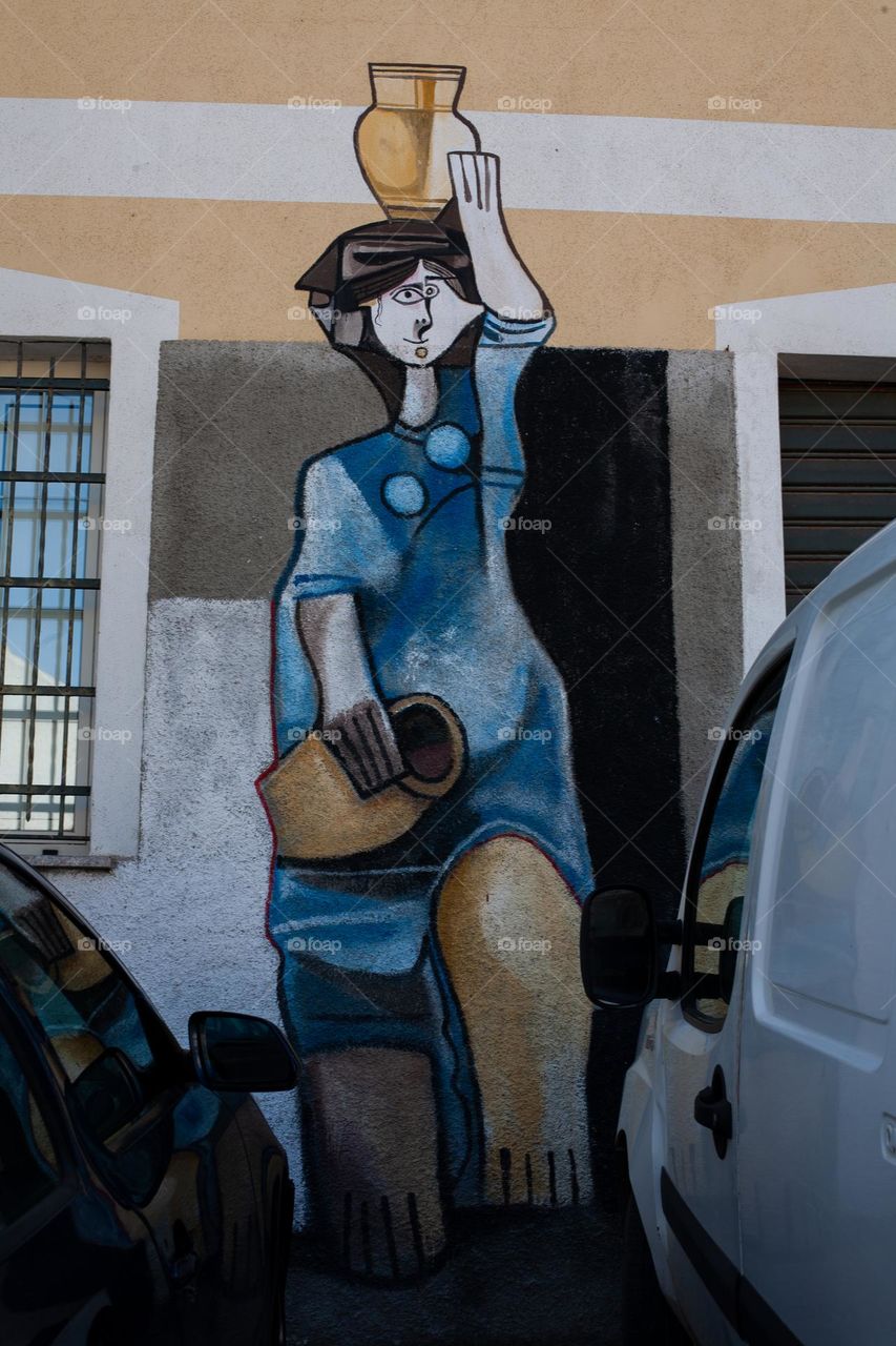 Mural artistry and cars in Orgosolo - Sardinia