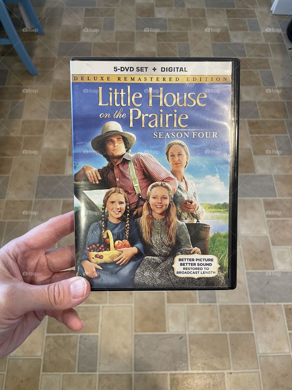 Woman’s hand holding Little House On The Prairie dvd set, watching classic tv shows on dvd, woman’s hand holding dvd, ready to watch season of Little House On The Prairie 