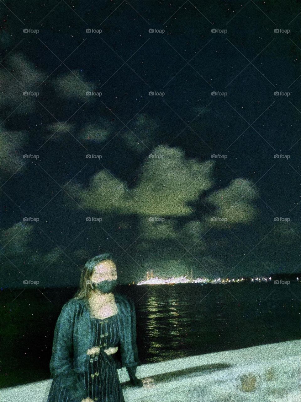 Woman sitting alone at night under starry sky.
