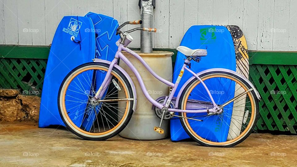 purple bicycle with blue boogey boards