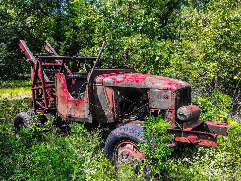 Rusty and retired logging truck sitting on the Missouri backroads. 