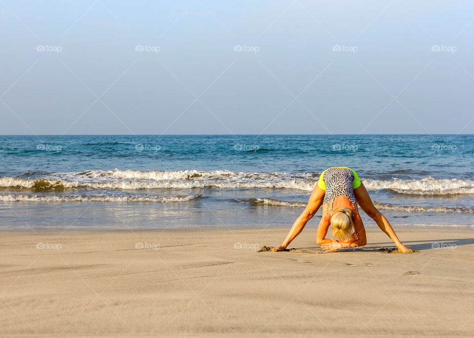 Morning exercise, yoga on the beach