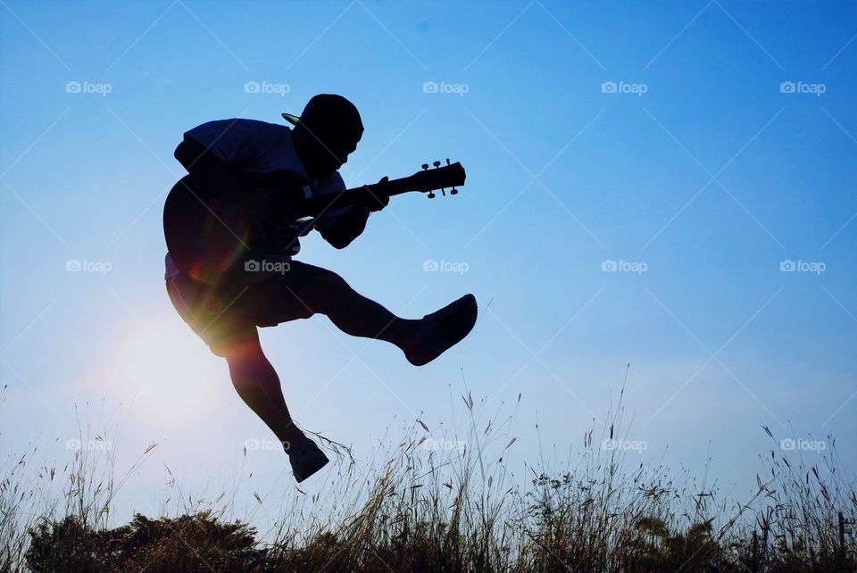 Beautiful jumping playing guitar.