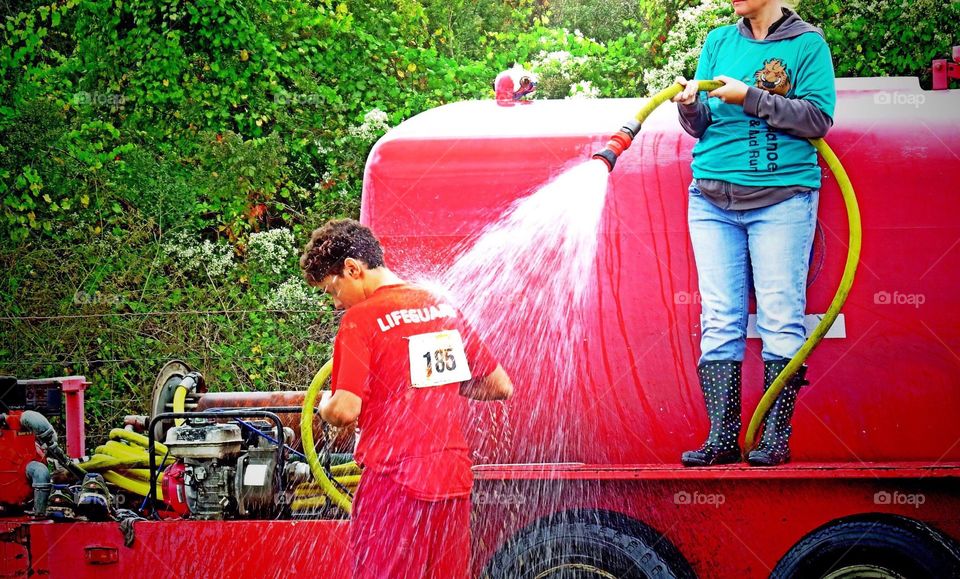 Racer receiving a cooling shower