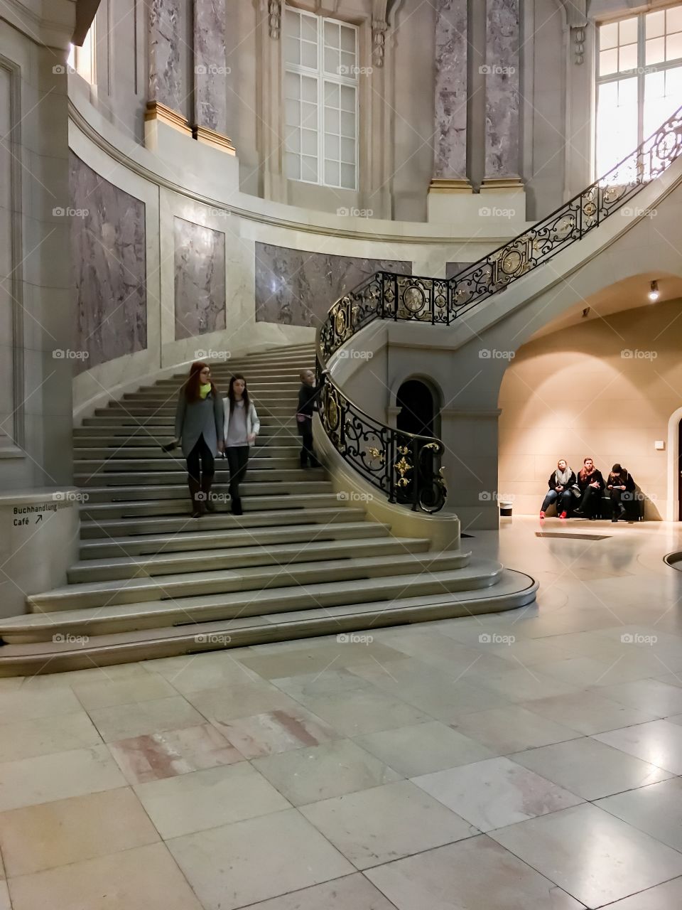 Mother with her daughter walking on staircase