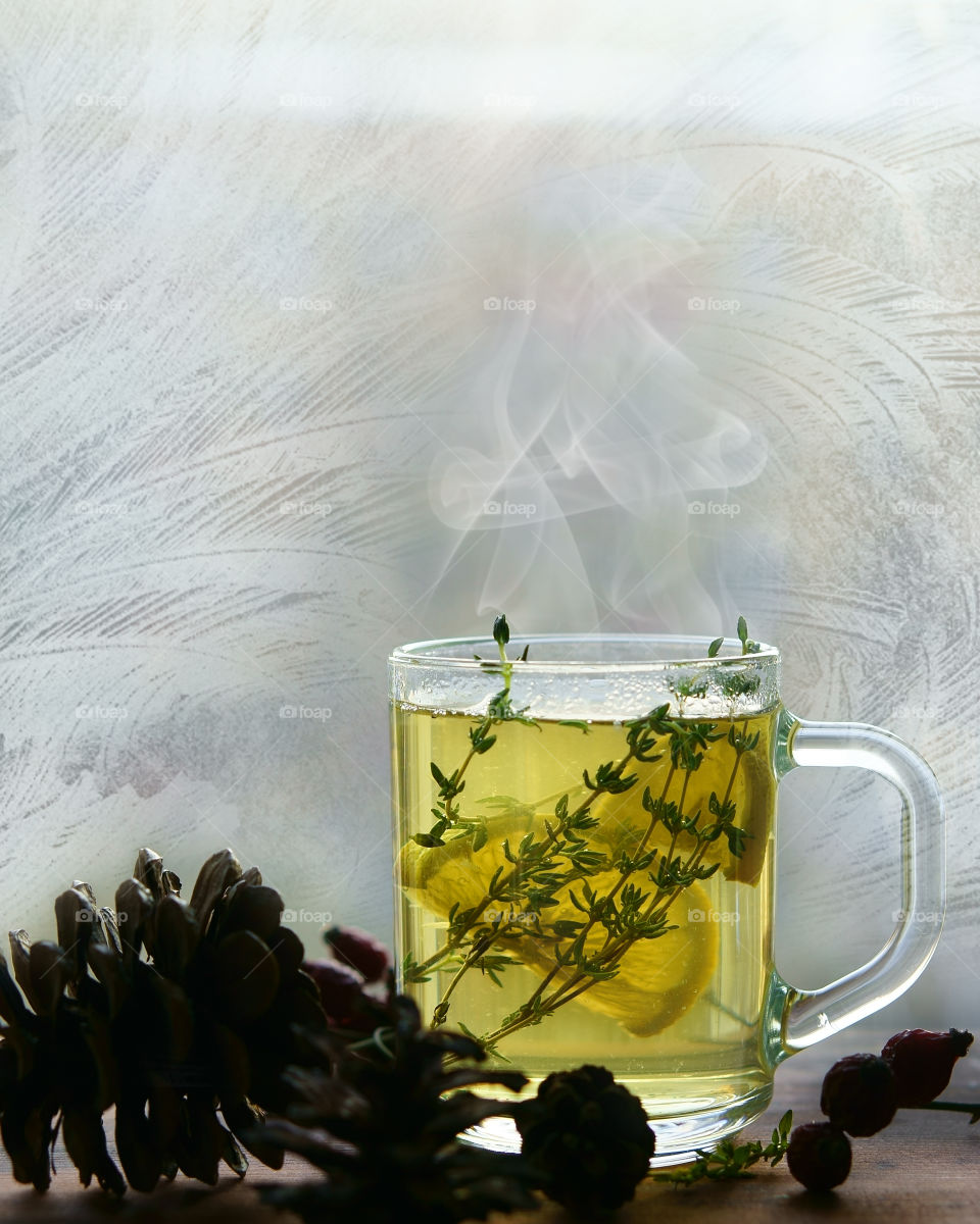 Cup of tea against frosty window